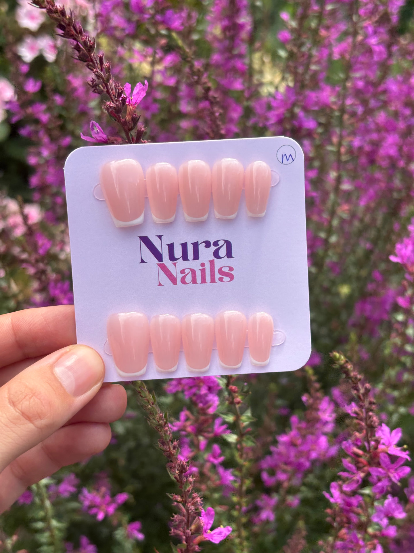 Nura Nails set with French tips among flowers